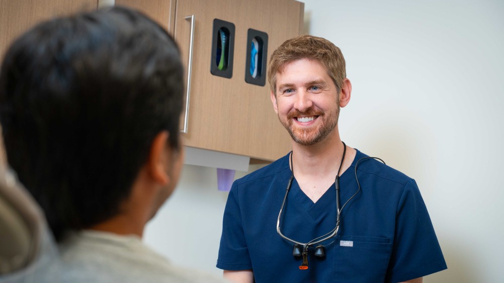 dentist speaking with patient in exam room