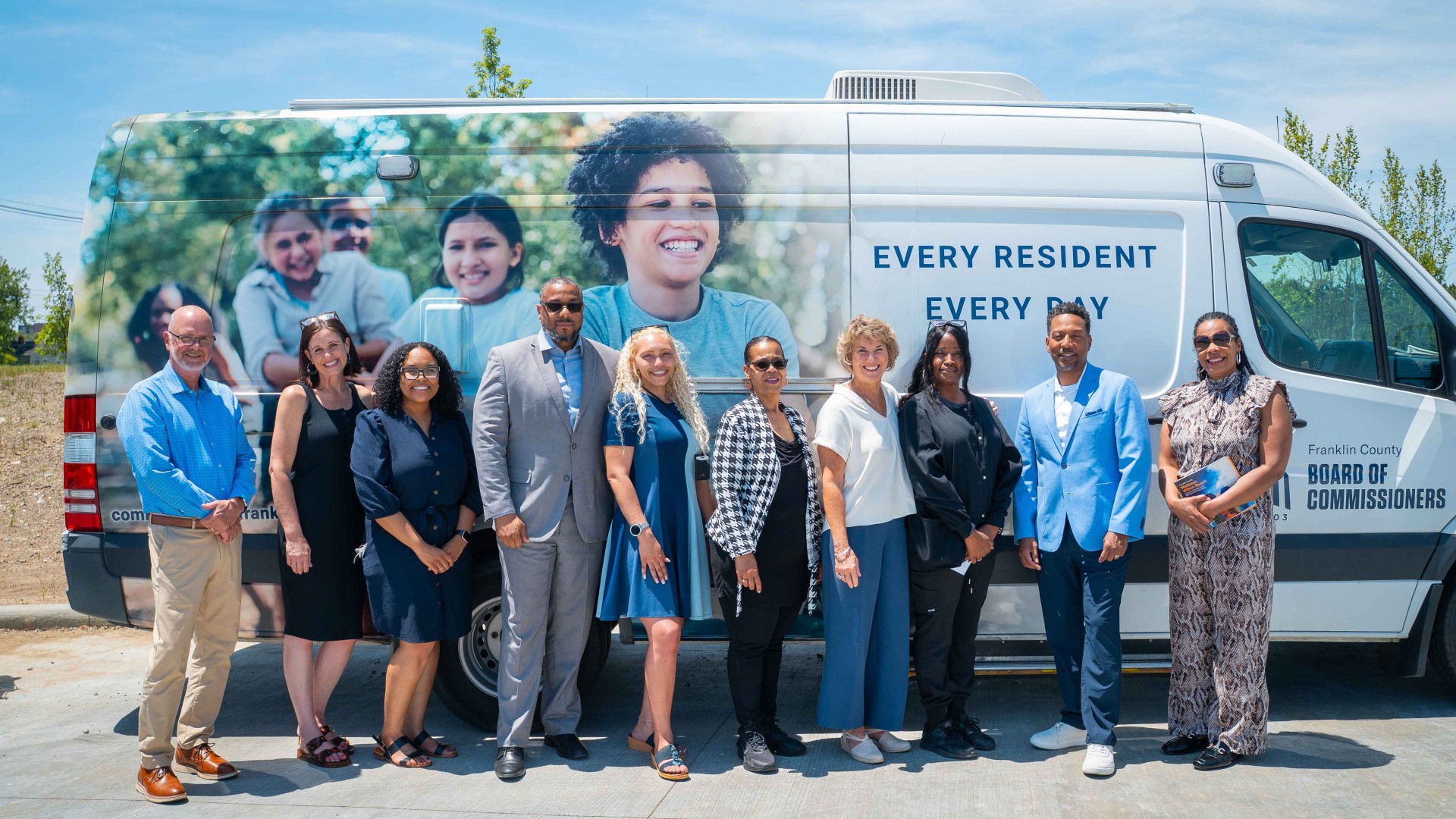 people posing in front of the Health and Human Services mobile unit